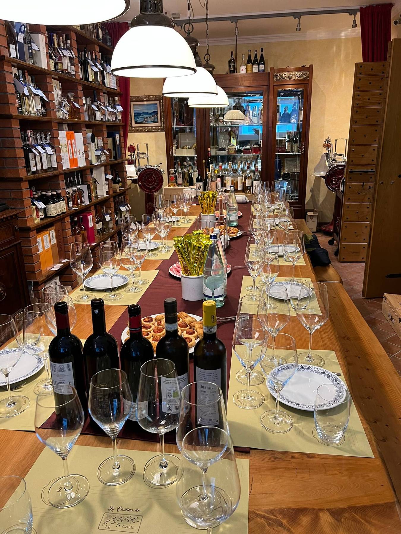 Langbord dekket med vinflasker og glass, klart for vinsmaking
